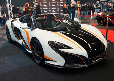 White McLaren convertible with orange accents