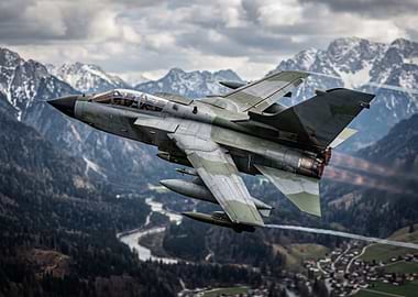 Military Jet Flying Over Mountains