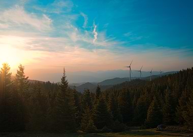 Wind Turbines in a Mountainous Forest at Sunset