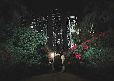 Man sitting in front of city skyline at night