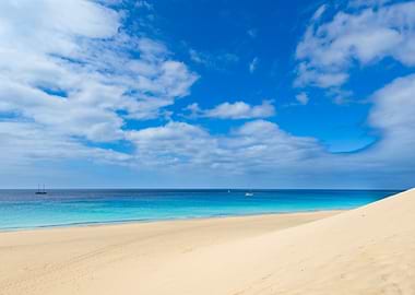 Tropical Beach with Sailboats and Dunes