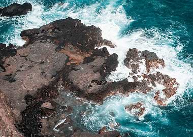 Waves crashing on volcanic rocks