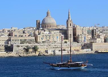 Sailing boat in front of Valletta cityscape