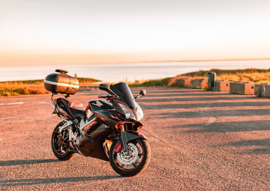 Honda VFR800 parked by the sea at sunset