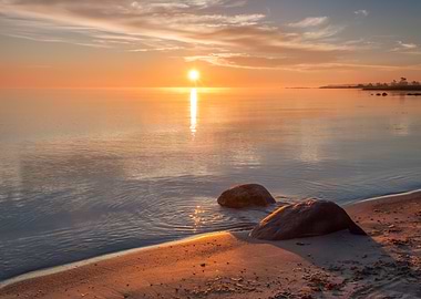 Sunset over a calm sea with rocks