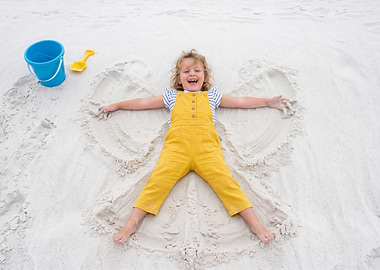 Girl Making a Sand Angel