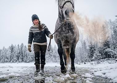 Woman and horse in snowy landscape