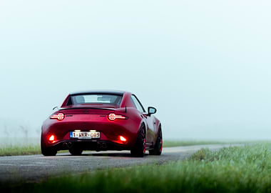 Red Mazda MX-5 on a Misty Road