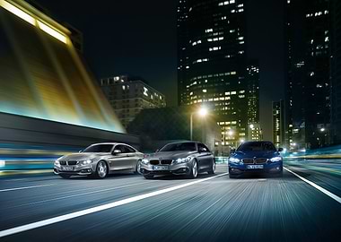 BMW Cars Driving at Night in City