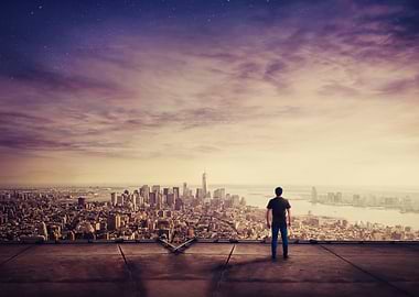 Man overlooking a city at dusk