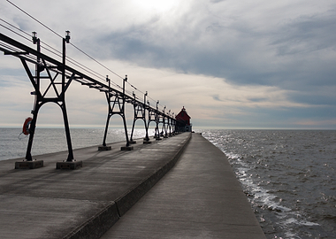 Pier leading to a red lighthouse