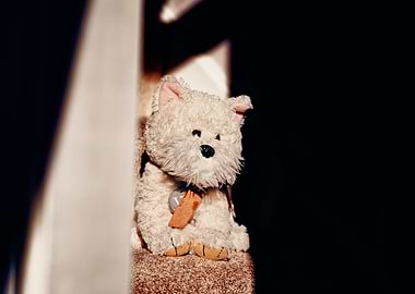 Plush dog sitting on stairs