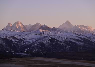 Snow-capped mountains at sunset