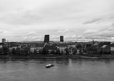 Cityscape of Basel City with River and Boat at River Rhine on a cloudly Day.