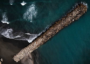 Aerial View of a Stone Jetty and Waves