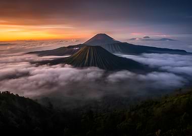 Volcanic peaks at sunrise above clouds