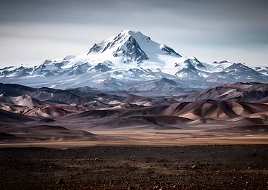 Snow-capped mountain range over arid landscape