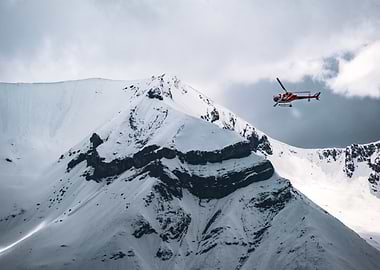 Helicopter flying over snowy mountains