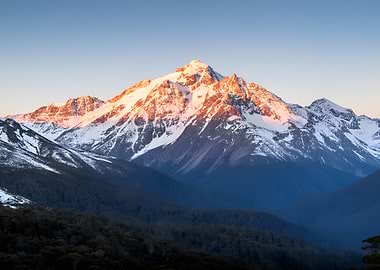 Snow-capped mountain peak at sunrise