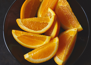 Orange Slices on a Dark Plate