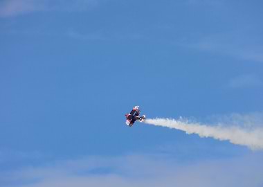 Biplane Performing Aerobatics with Smoke Trail