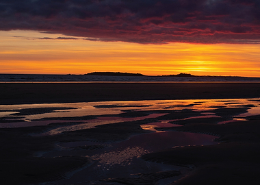 Sunset over a beach with tide pools
