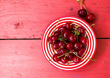 Cherries in a Red and White Striped Bowl