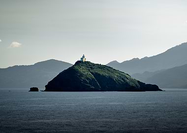 Palmaiola island lighthouse overlooking the sea, Italy