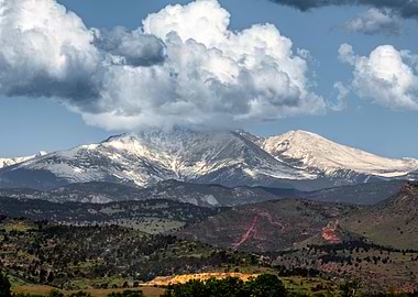 Snow-capped Mount Meeker under dramatic clouds
