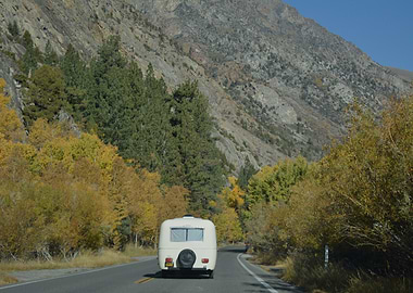 RV traveling through autumn mountains