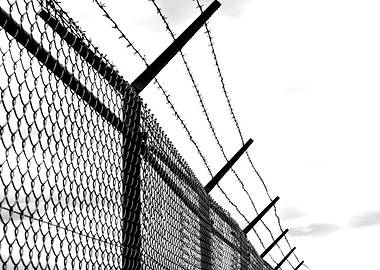 Barbed Wire Fence Against Sky