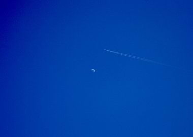 Airplane and Moon in Blue Sky