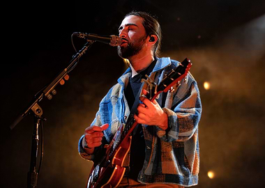 Musician playing guitar on stage