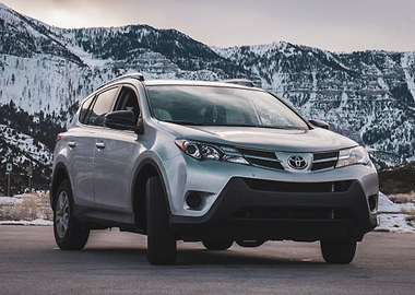 Silver Toyota RAV4 in Snowy Mountains