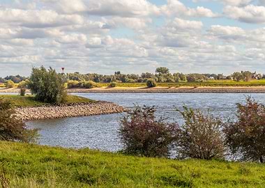 River landscape with trees and clouds