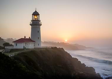 Lighthouse at Sunrise Over the Ocean
