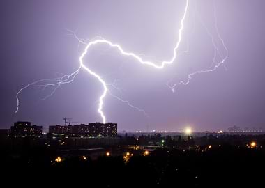 Lightning strikes over city at night