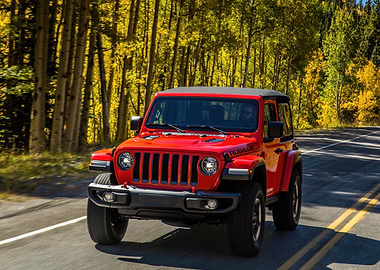 Red Jeep Wrangler Rubicon Driving Through Autumn Forest
