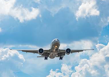 Boeing 777 landing with cloudy sky