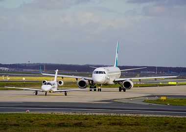 Two Airplanes Taxiing on Airport Runway