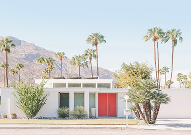 Palm Springs, USA | Mid-century modern home with red door and palm trees in Valley desert and mountains